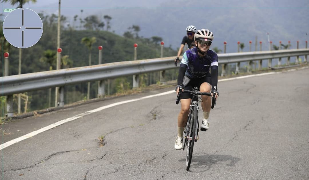 two cyclists riding up a hill