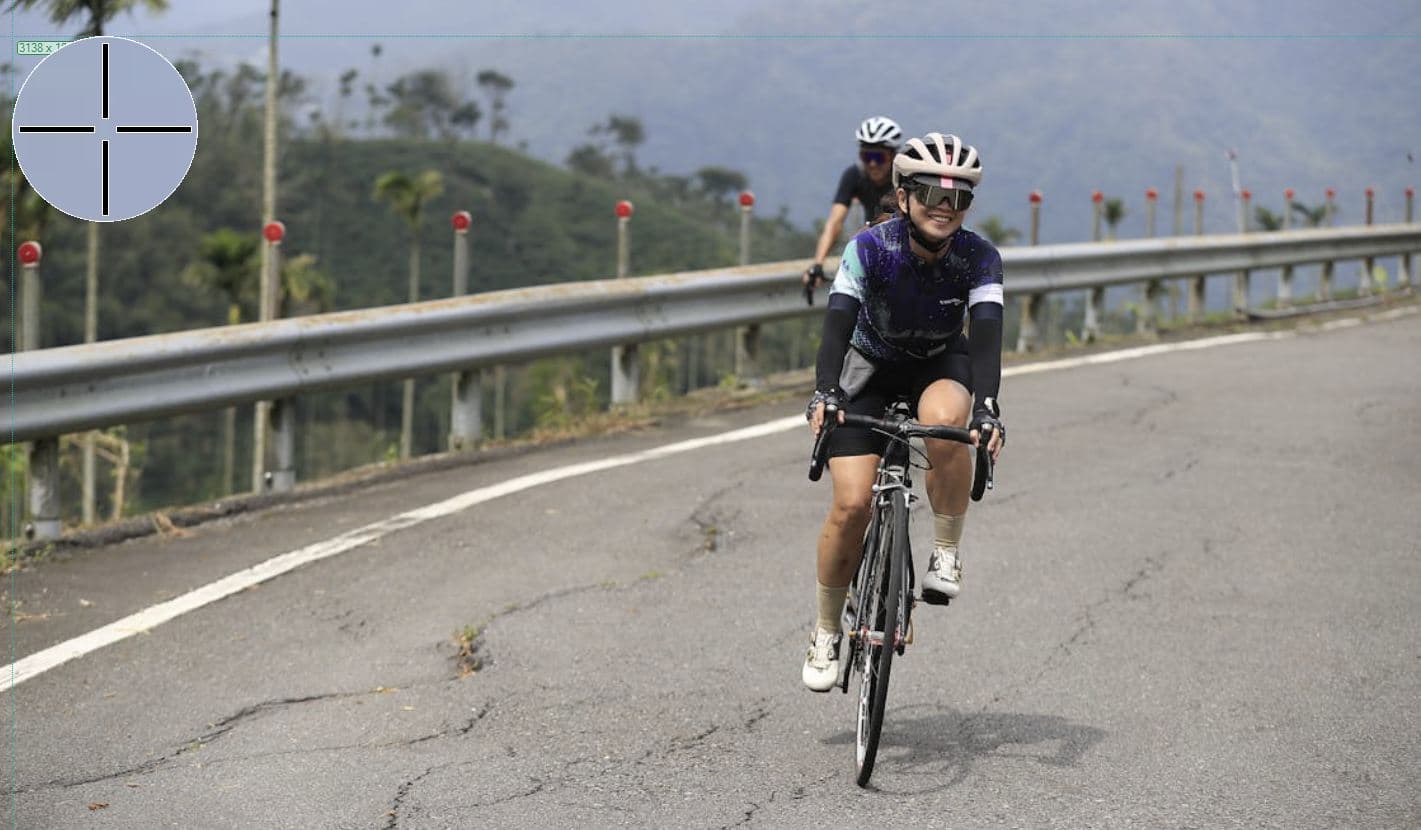 two cyclists riding up a hill